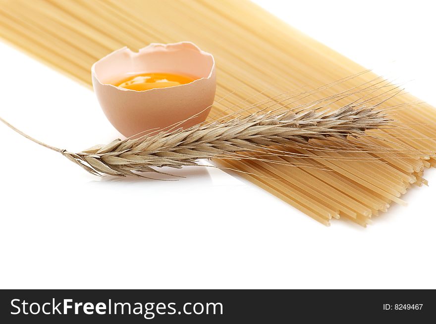 Alone broken egg, ear and spaghetti isolated on a white background. Alone broken egg, ear and spaghetti isolated on a white background.