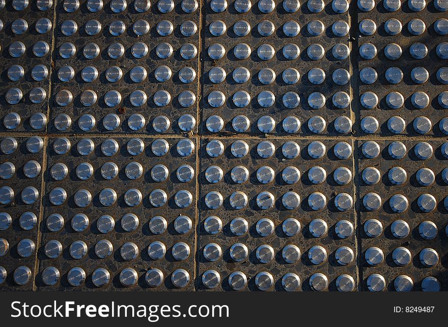 Pavement tiles with steel studs