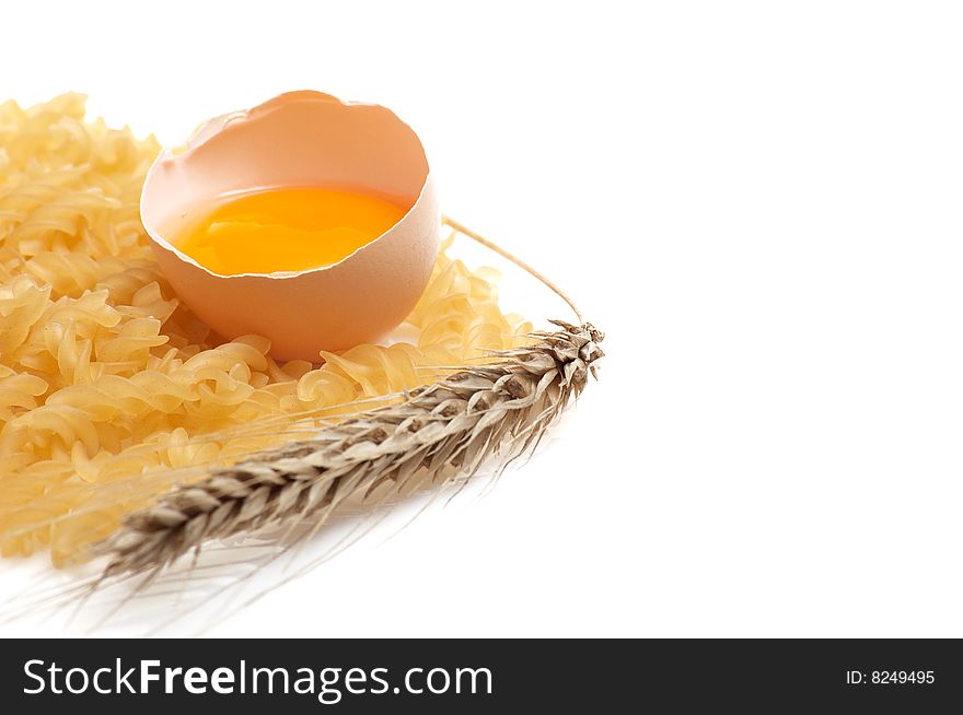 Broken chicken  egg,pasta and ear isolated on a white background. Broken chicken  egg,pasta and ear isolated on a white background.