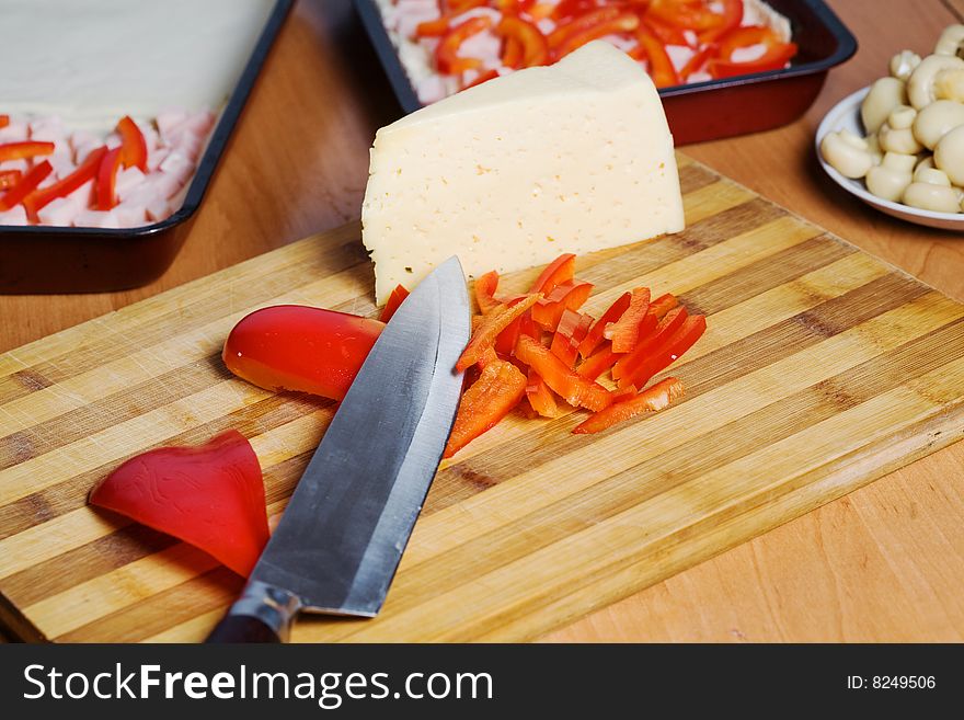 Stock photo: an image of food in the kitchen: mushrooms, cheese, paprika and knife. Stock photo: an image of food in the kitchen: mushrooms, cheese, paprika and knife