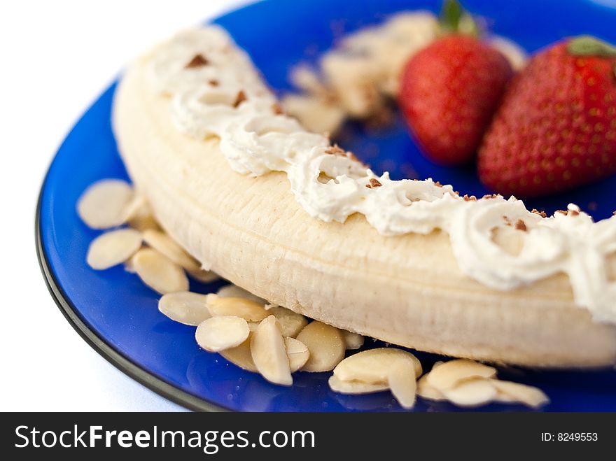 Strrawberry banana dessert with cream and almonds