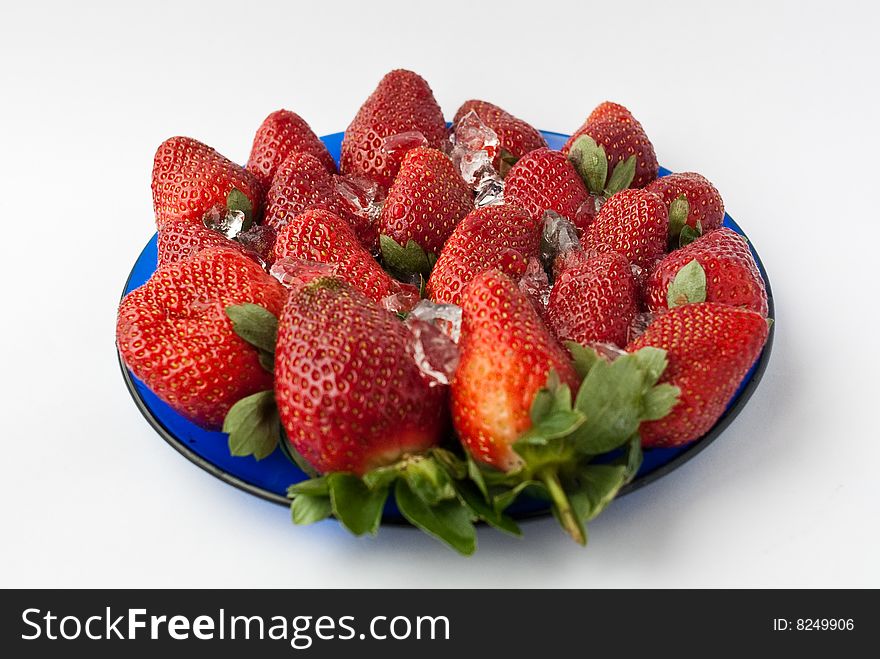 Blue plate with strawberries and ice. Blue plate with strawberries and ice