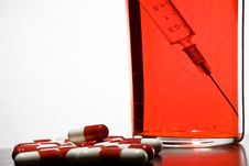 Tablets, A Syringe Into A Glass With Blood Stock Photo Tablets, A Syringe Into A Glass With Blood Stock Photo