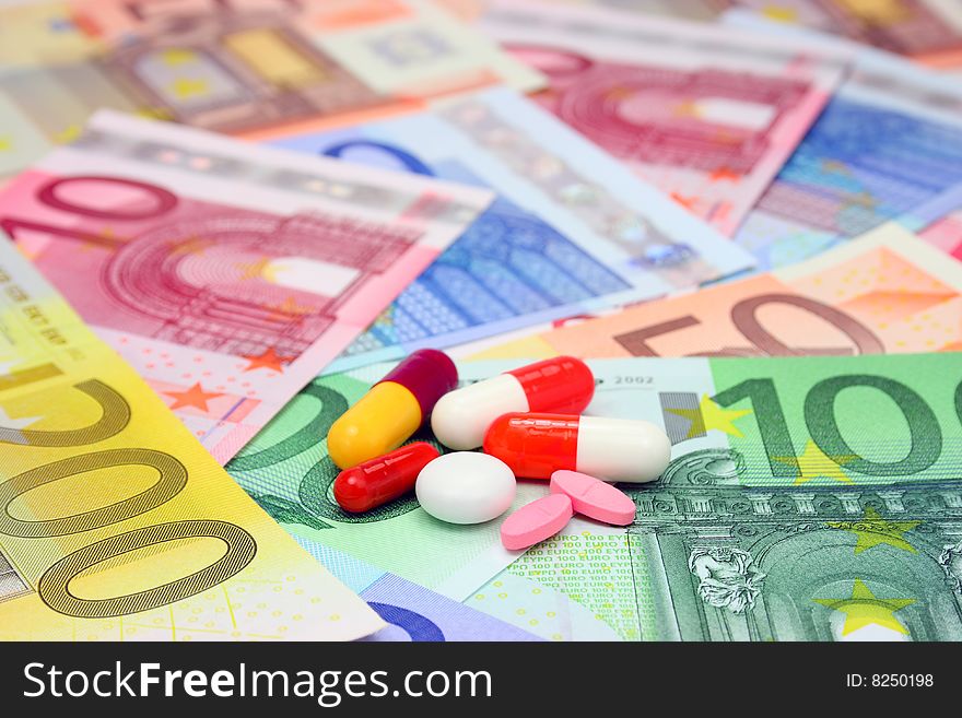 Assorted pills and capsules over euro money. Assorted pills and capsules over euro money