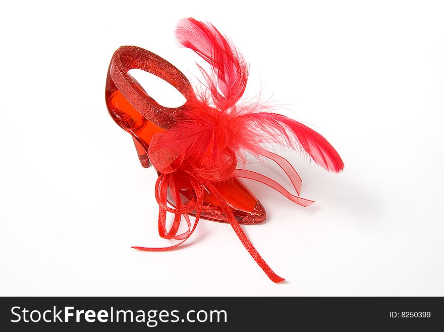 Red crystal slippers with feathers, isolated on white