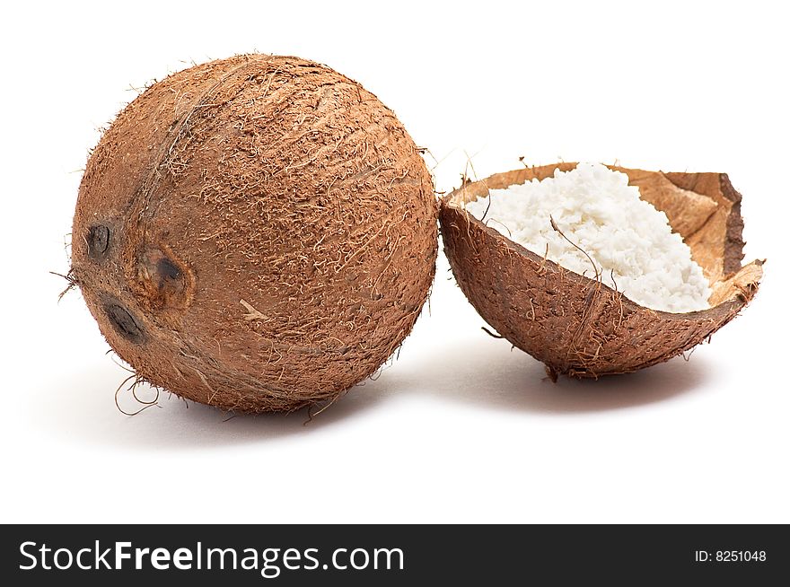 Half part of coconut with powder inside shell isolated on a white background. Half part of coconut with powder inside shell isolated on a white background.