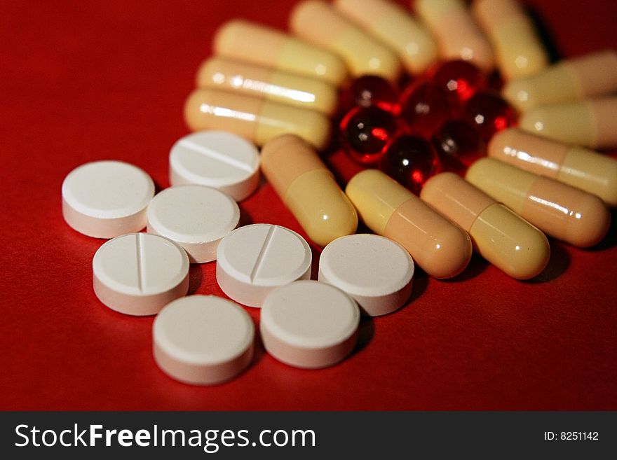 Vitamines in red and white tablets in close up