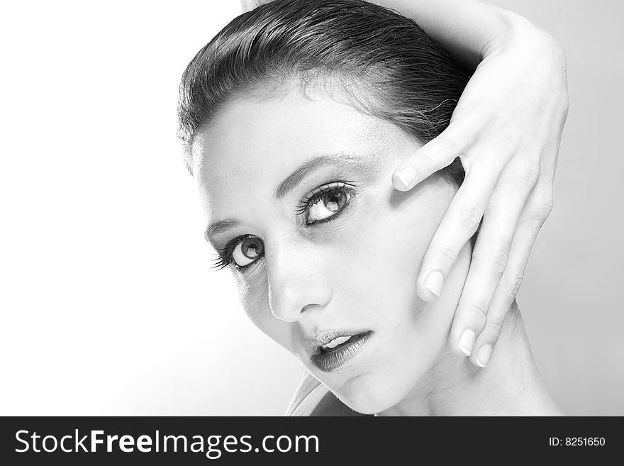 Attractive young lady with extravegant makeup and black eyelashes black and white background with some gray