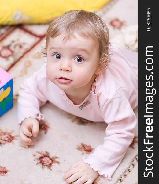 Little girl playing on the floor - shallow DOF