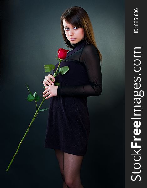 Beautiful girl with rose, studio shot