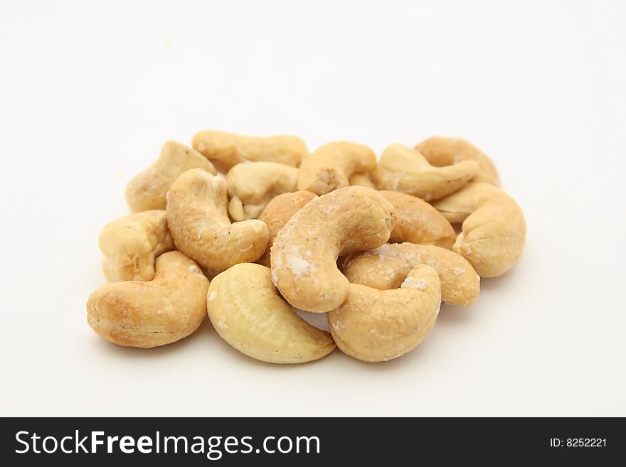 Salted indian walnuts on white background