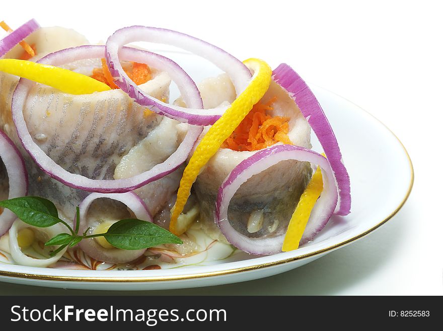 Herrings with vegetables on the plate isolated. Herrings with vegetables on the plate isolated