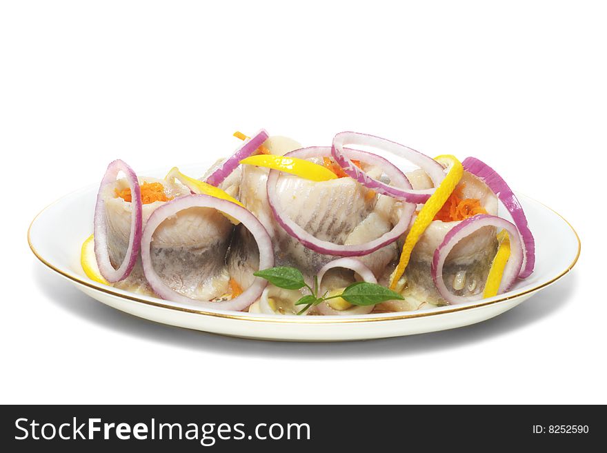 Herrings with vegetables on the plate isolated. Herrings with vegetables on the plate isolated