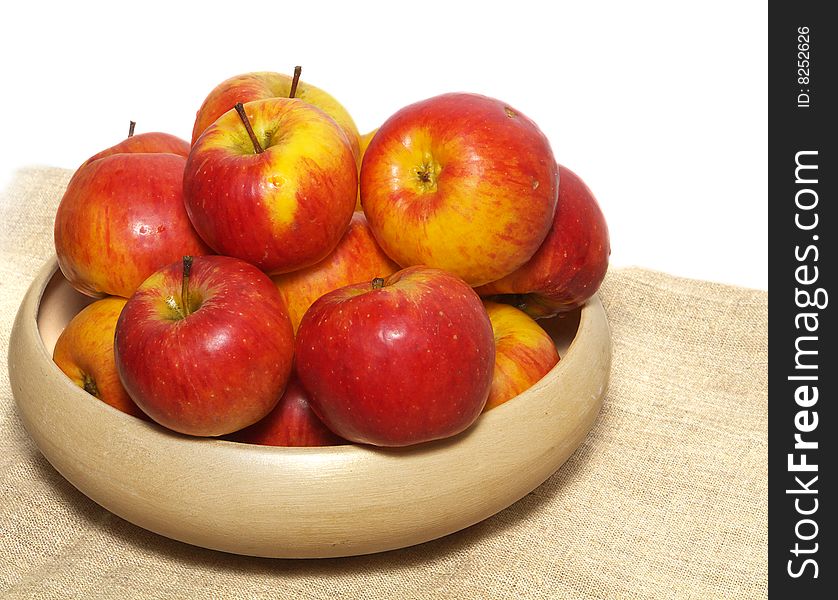 An isolated pottery bowl filled with fresh delicious ripe apples. An isolated pottery bowl filled with fresh delicious ripe apples