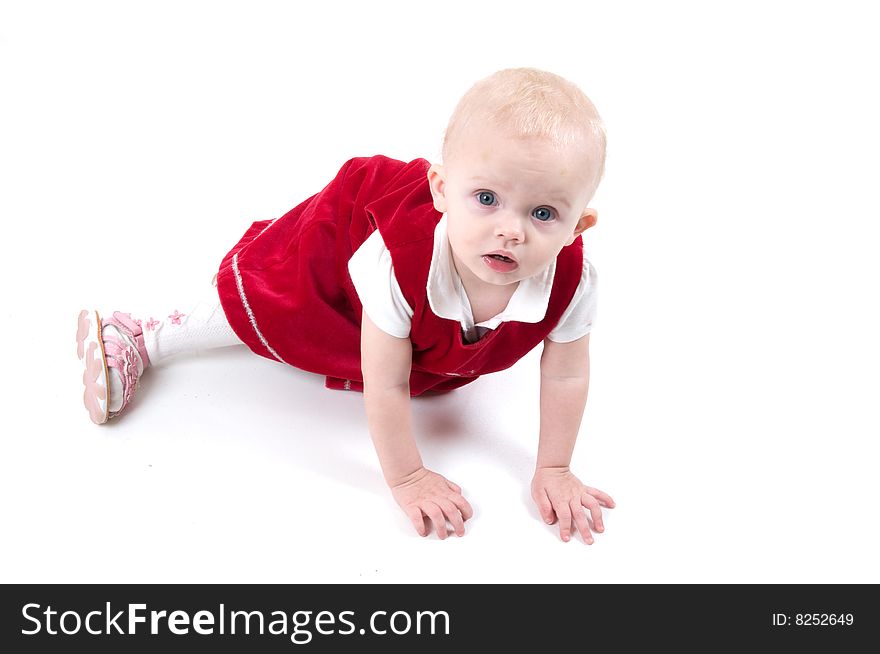 Baby in red is sitting on the floor. Baby in red is sitting on the floor