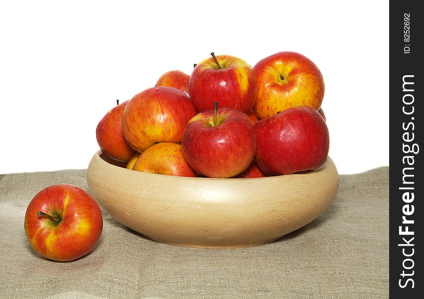 An isolated pottery bowl filled with fresh delicious ripe apples. An isolated pottery bowl filled with fresh delicious ripe apples