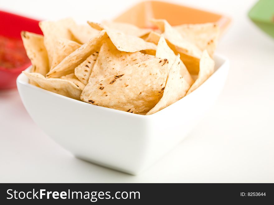 Tortilla chips with salsa in colorful bowls. Tortilla chips with salsa in colorful bowls