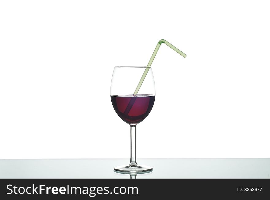 Wine glass with a drinking straw. Wine glass with a drinking straw