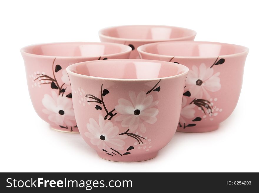 Four pink cups isolated on white background