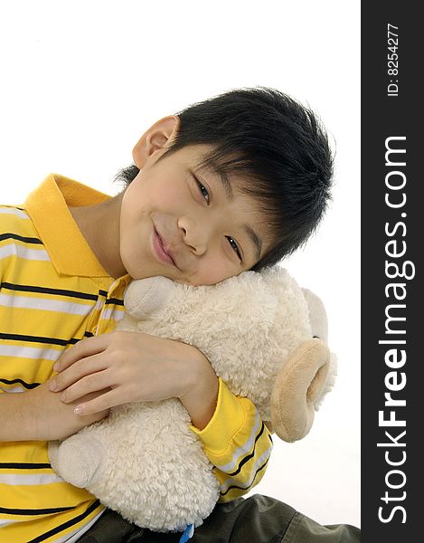 Happy boy cuddling a soft toy sheep. Happy boy cuddling a soft toy sheep