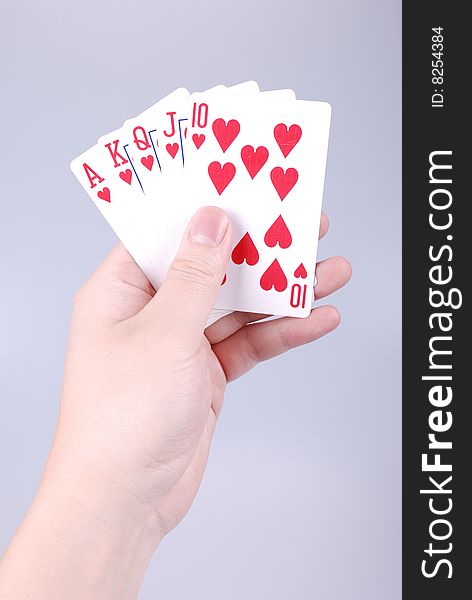 Poker in a hand with gray background. Poker in a hand with gray background