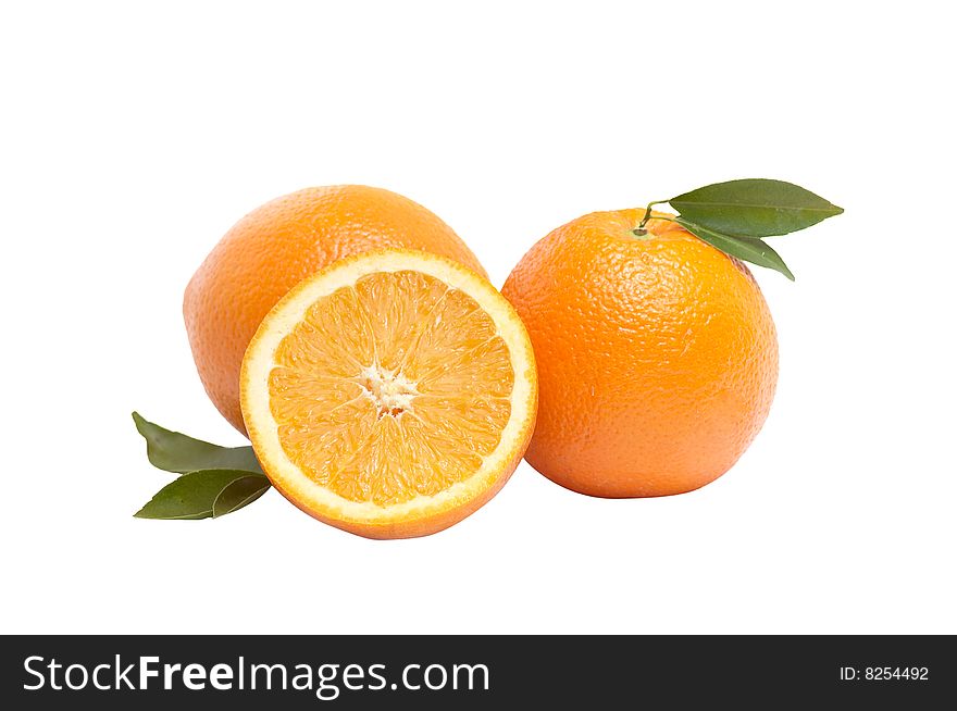 Ripe,juicy oranges and green leaves isolated on a white background. Ripe,juicy oranges and green leaves isolated on a white background.