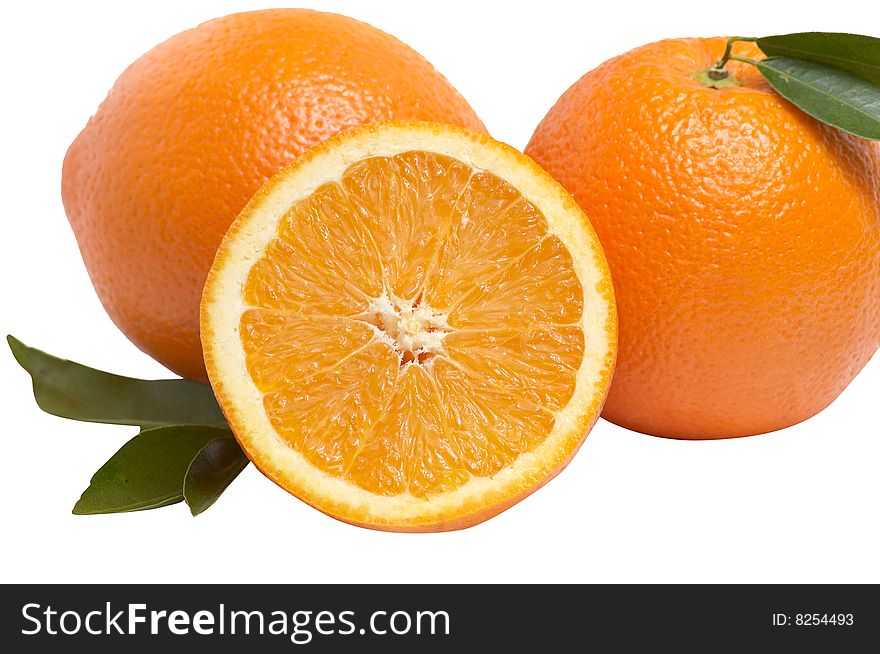 Juicy,ripe oranges and green leaves isolated on a white background. Juicy,ripe oranges and green leaves isolated on a white background.