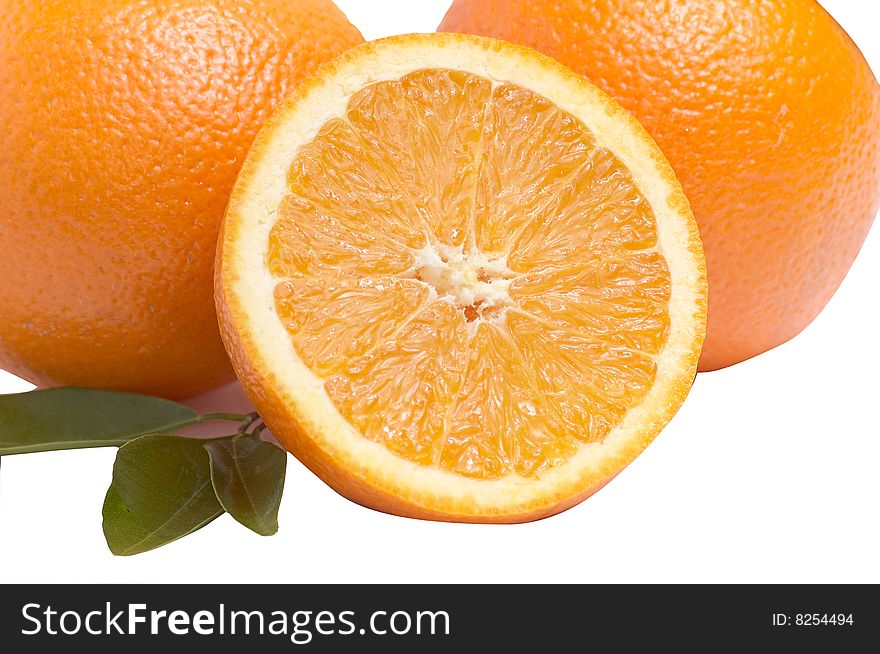 Juicy,ripe oranges with green leaves isolated on a white background. Juicy,ripe oranges with green leaves isolated on a white background.