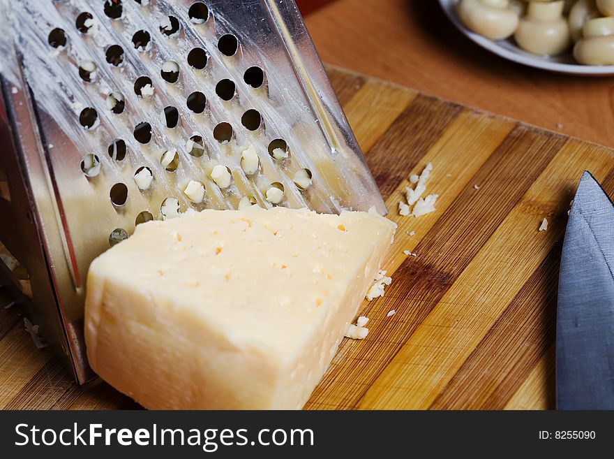 Stock photo: an image of food in the kitchen: mushrooms and cheese, grater