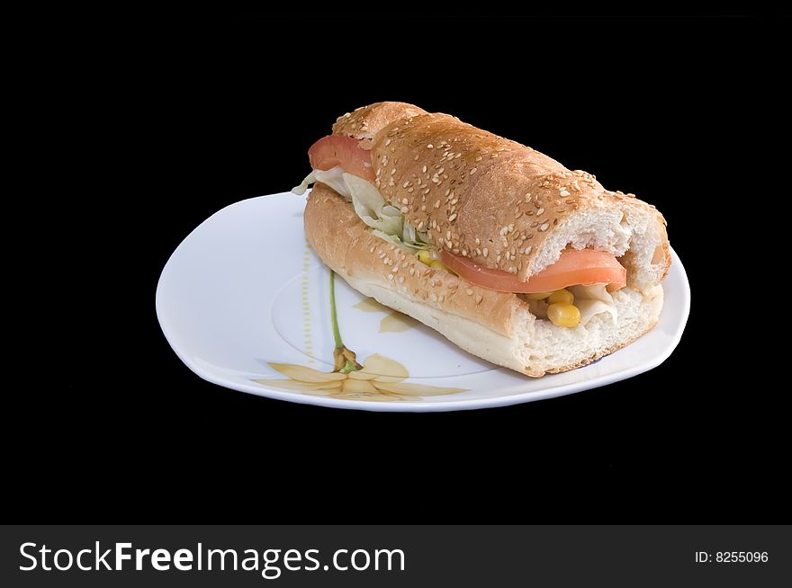 Baguette sandwich on plate, black background