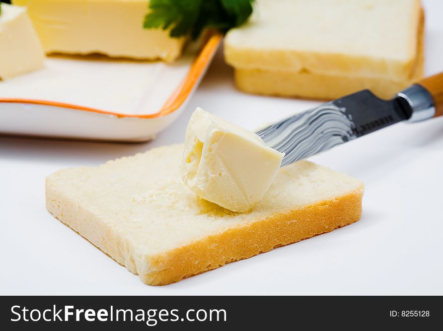 Stock photo: an image of yellow butter on bread and a knife. Stock photo: an image of yellow butter on bread and a knife