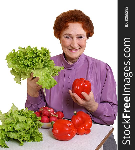 The woman is pleased to fresh vegetables on a white background. The woman is pleased to fresh vegetables on a white background