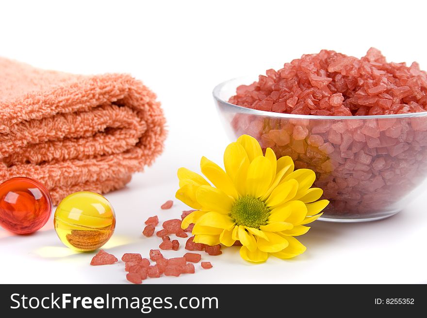 Bath salt, towels and yellow flower. Bath salt, towels and yellow flower