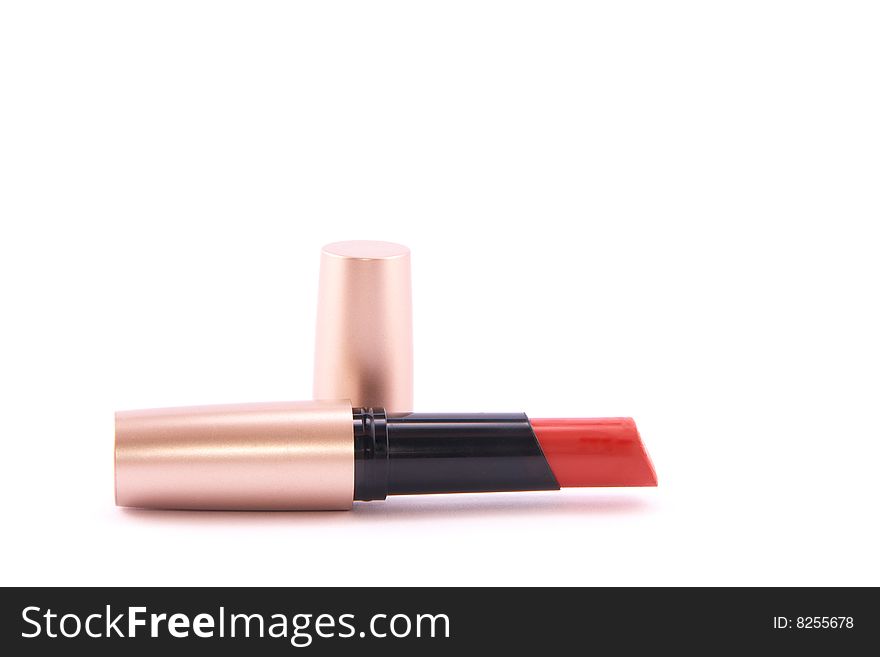 Open tube of red lipstick on white background