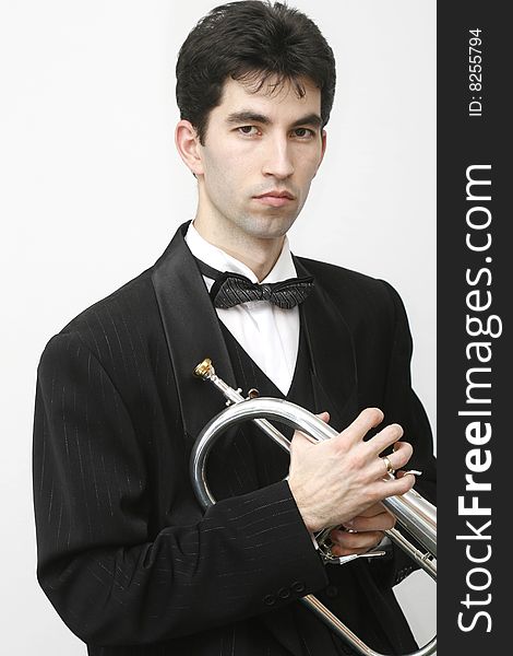 Trumpet player in a luxury suit and his trumpet