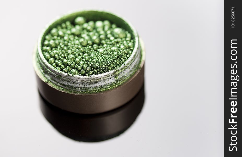 Green glittering eyeshadow on mirror. Green glittering eyeshadow on mirror