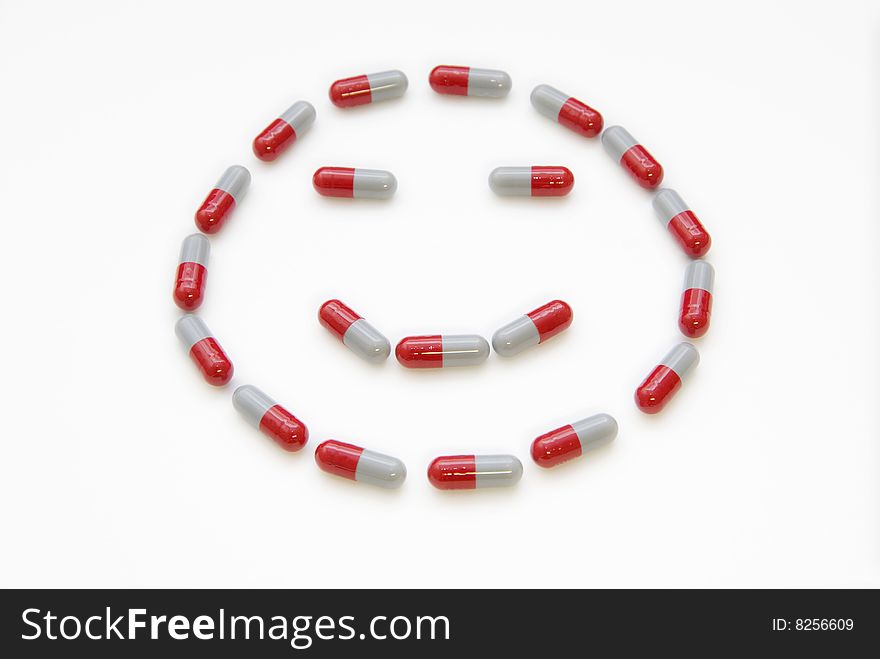 The pill constitute a smile face on white. The pill constitute a smile face on white