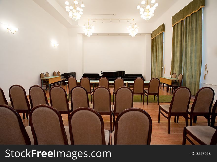 Empty small concert room with piano