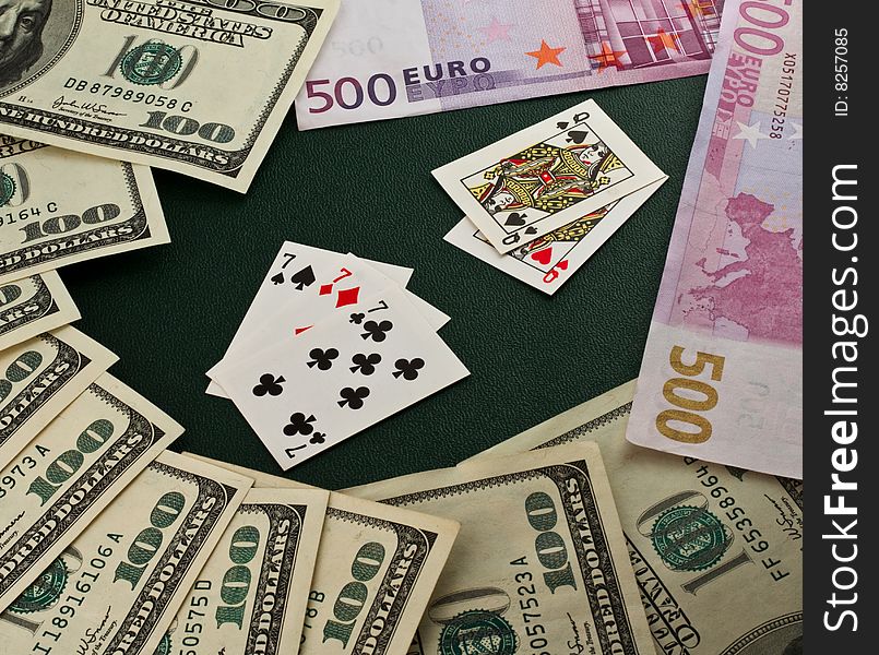 Playing cards, euro and dollars on a green background. Playing cards, euro and dollars on a green background