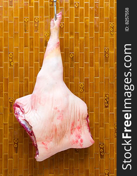 Fore leg of Italian pork. Forequarter of pork attached to a hook