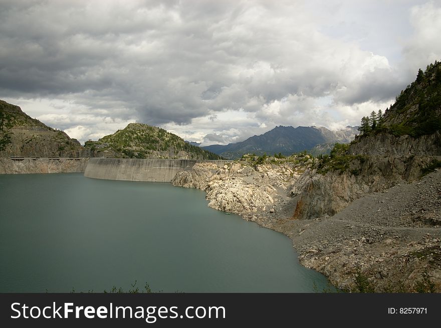 Panoramic view on swiss mountain lake with a huge dam, Switzerland. Panoramic view on swiss mountain lake with a huge dam, Switzerland