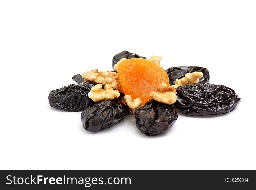 Pattern of dried apricot,walnuts and prunes isolated on a white background. Pattern of dried apricot,walnuts and prunes isolated on a white background.