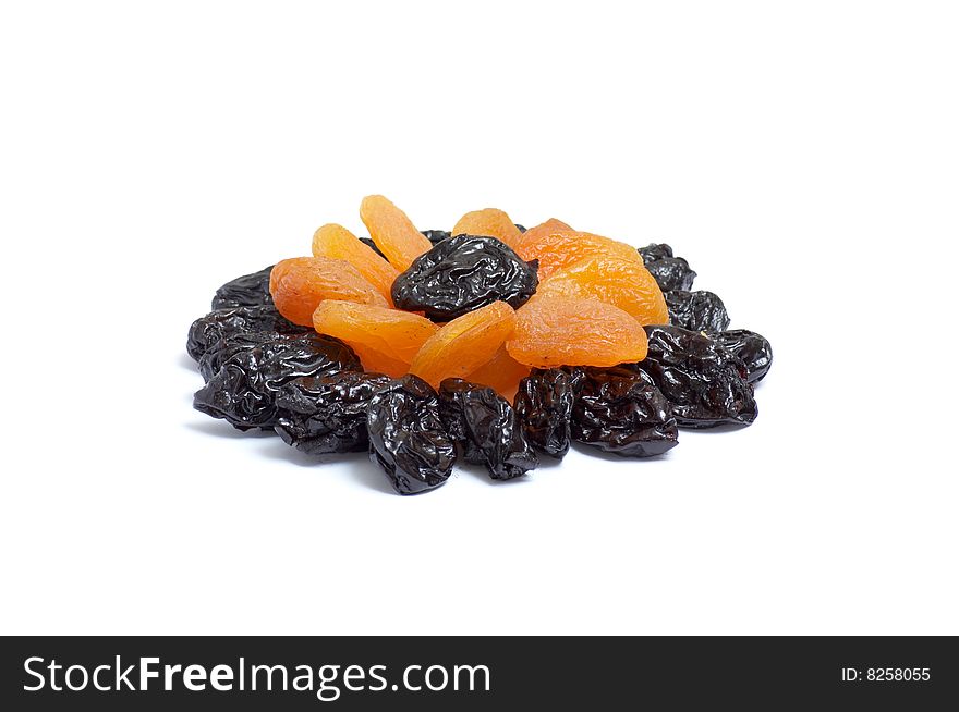 Pattern of dried apricot and  prunes isolated  on a white background. Pattern of dried apricot and  prunes isolated  on a white background.
