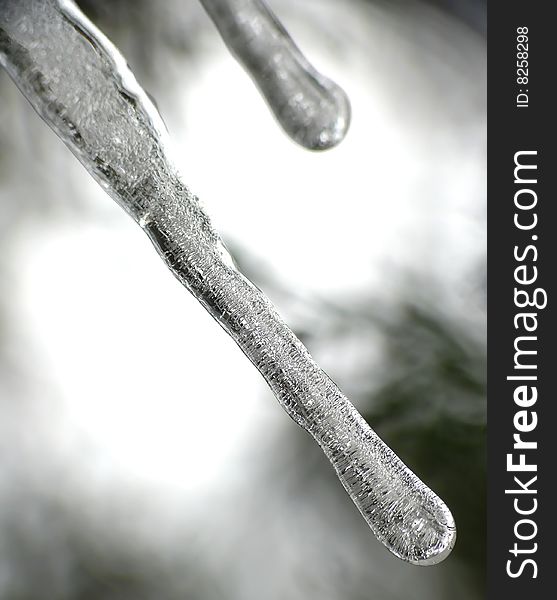 Icicles on black and grey background. Icicles on black and grey background