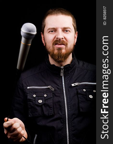 Portrait of rockstar male musician playing with microphone. Portrait of rockstar male musician playing with microphone