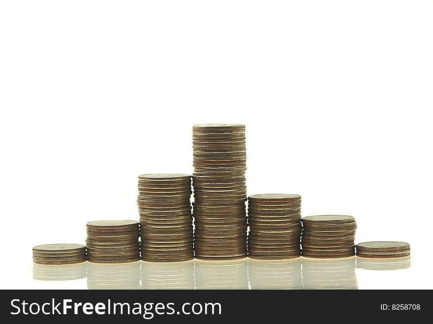 Stacks coins isolated on a white. Close up. Stacks coins isolated on a white. Close up