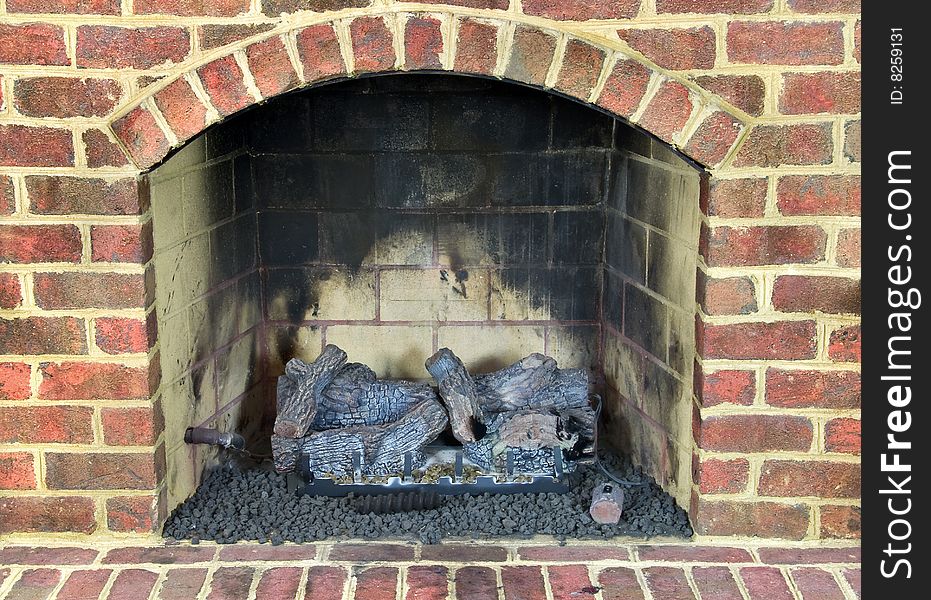 Close up of gas fireplace surrounded with brick. Close up of gas fireplace surrounded with brick.