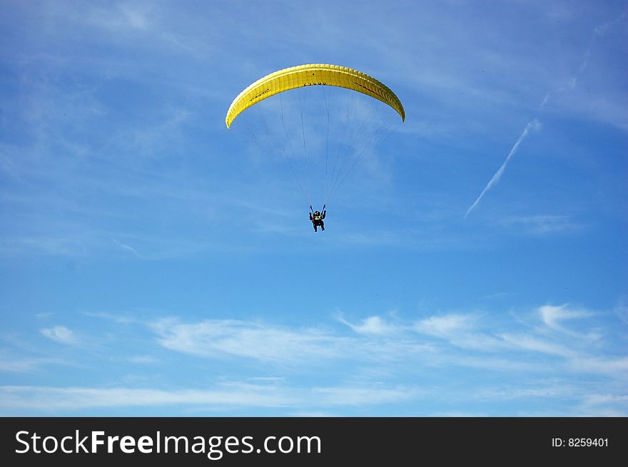 Parachuter surfing the blue sky.