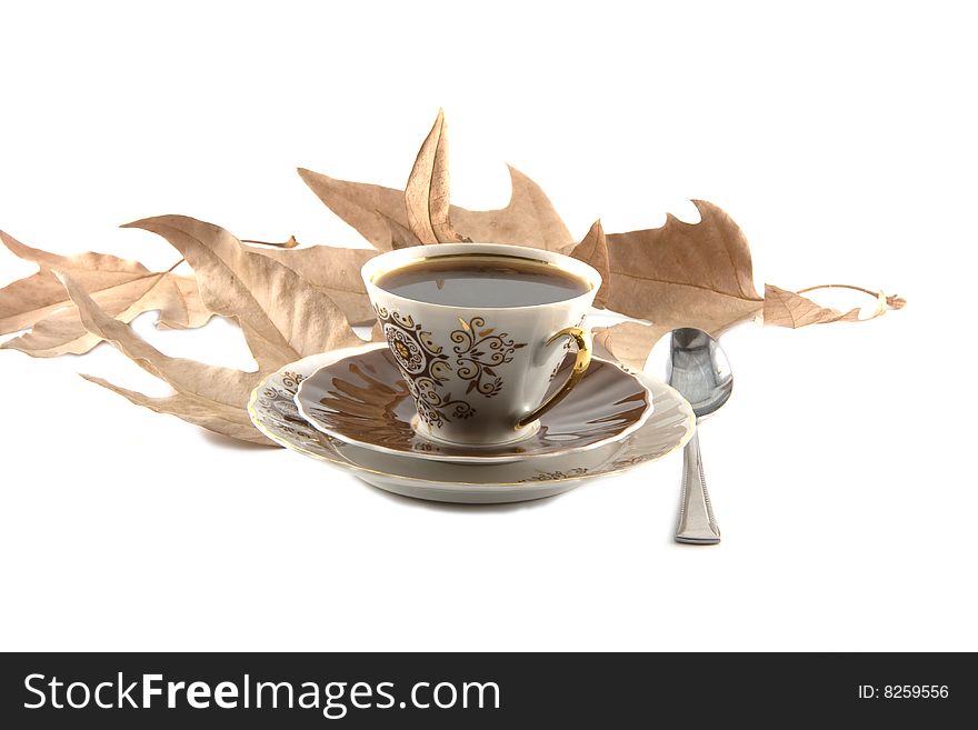 Cup of cofe on the white background with leaves. Cup of cofe on the white background with leaves