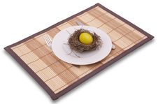 Gold Egg In A Nest Served On A Plate Stock Image
